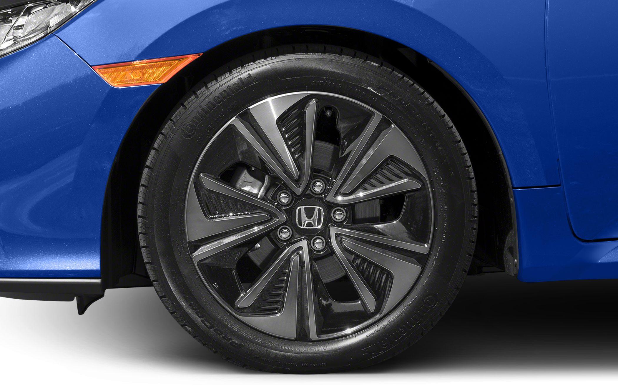 Close-up of alloy wheel with unique multi-spoke design and Continental tire.