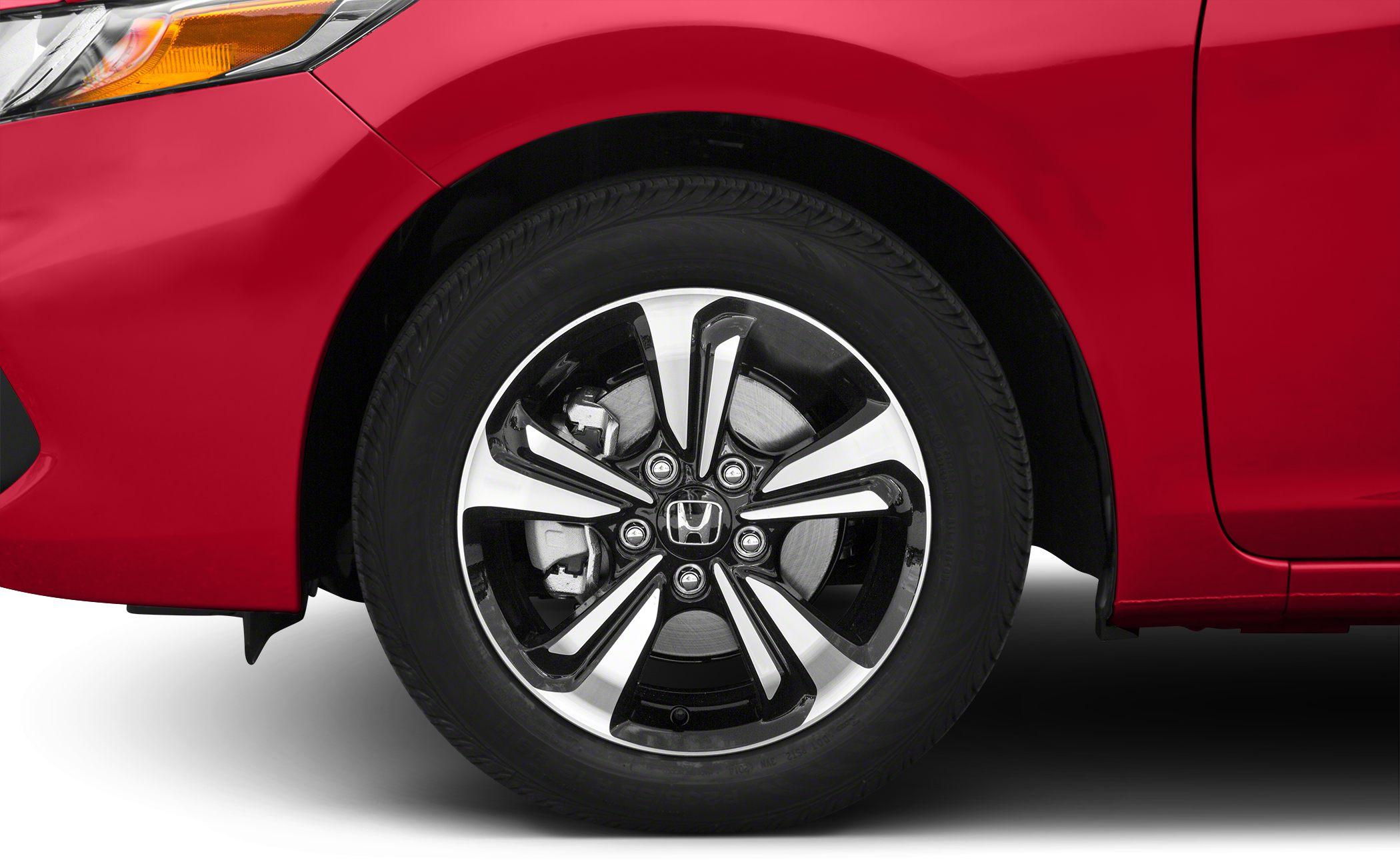 Close-up of alloy wheel and front fender of a red coupe