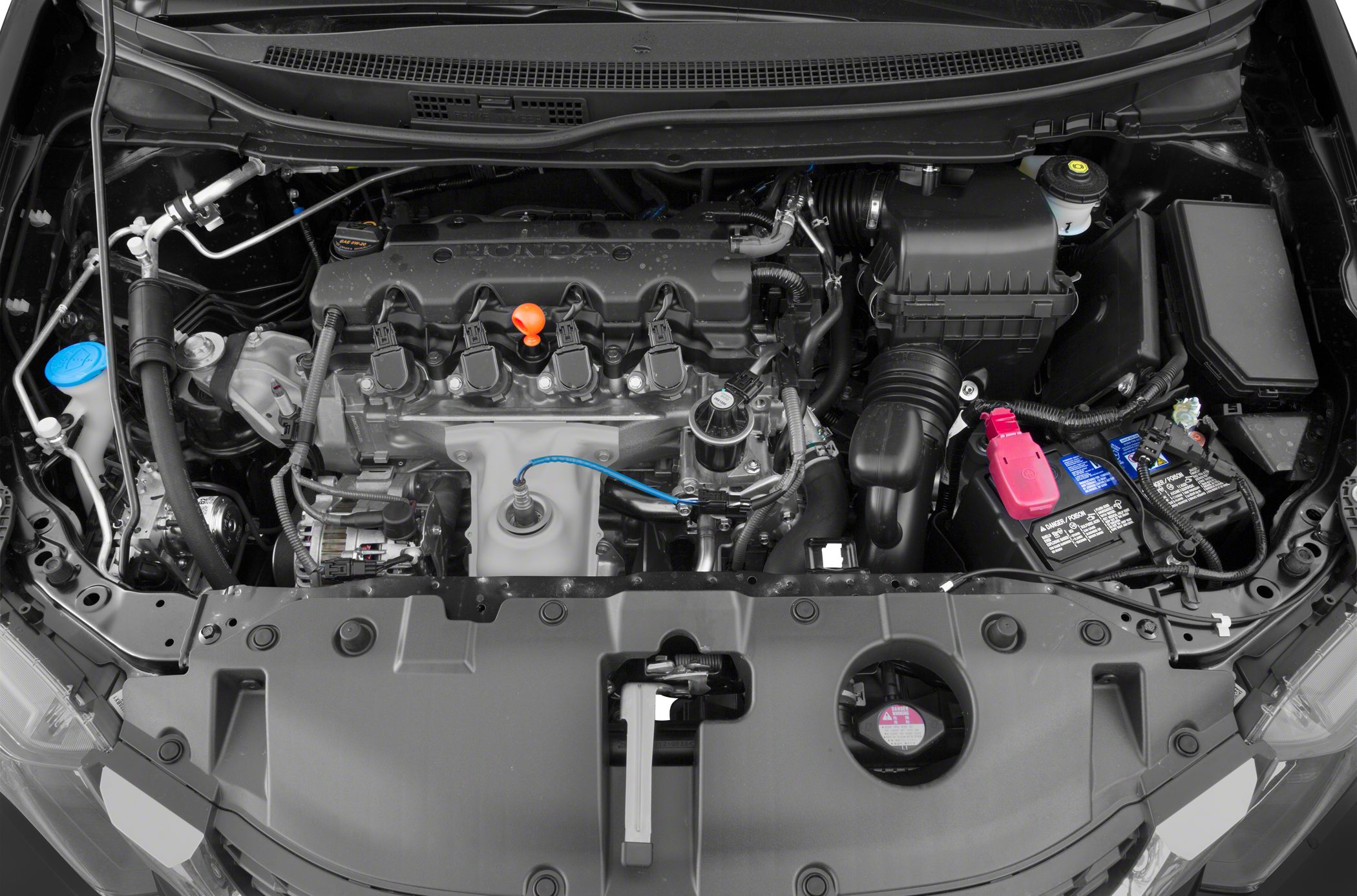Engine bay with ignition coils, battery, and air intake components.