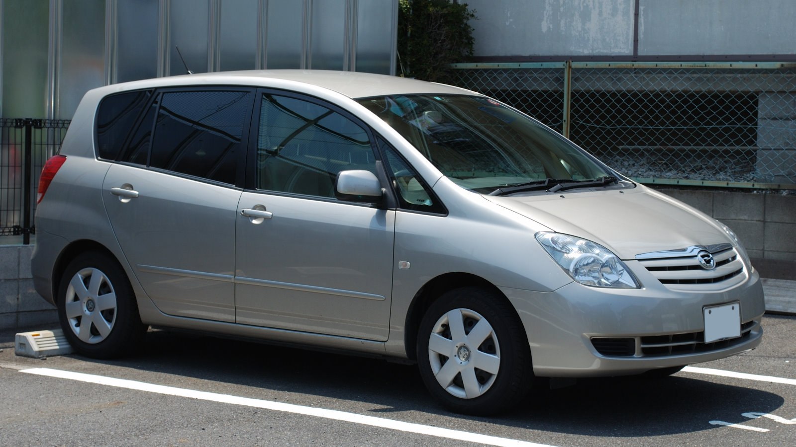 Silver compact MPV side profile with tinted windows and alloy wheels