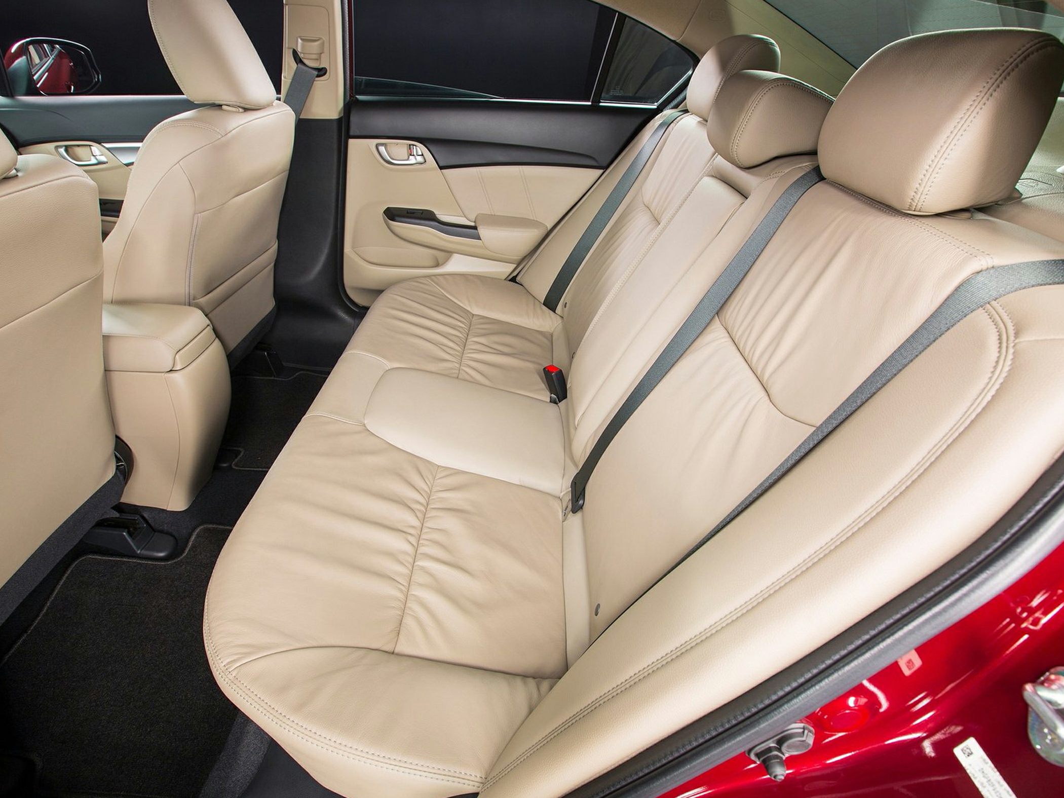 Beige leather rear seats with seatbelts and door interior