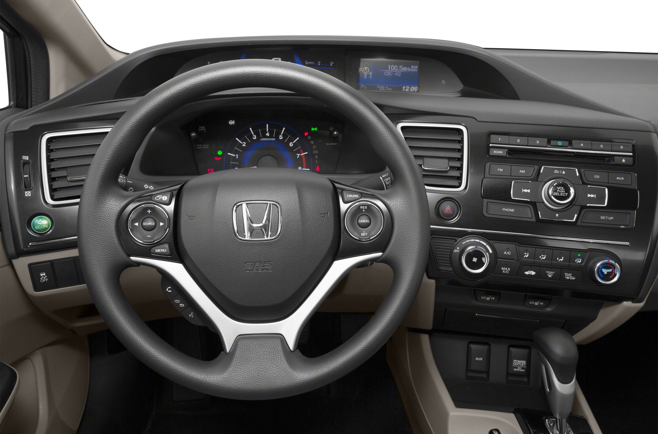 Steering wheel with controls and dashboard with infotainment system