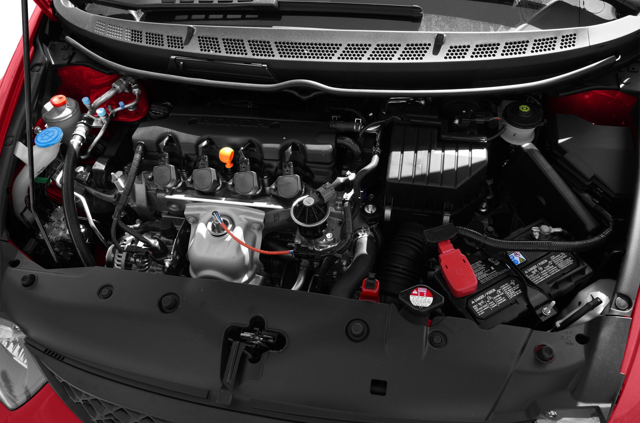 Engine bay showing battery, engine cover, fluid reservoirs, and wiring