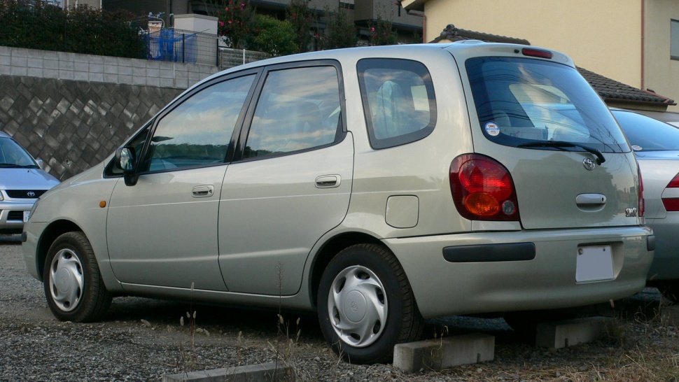 Rear side view of a compact hatchback with distinctive rear window and taillights.