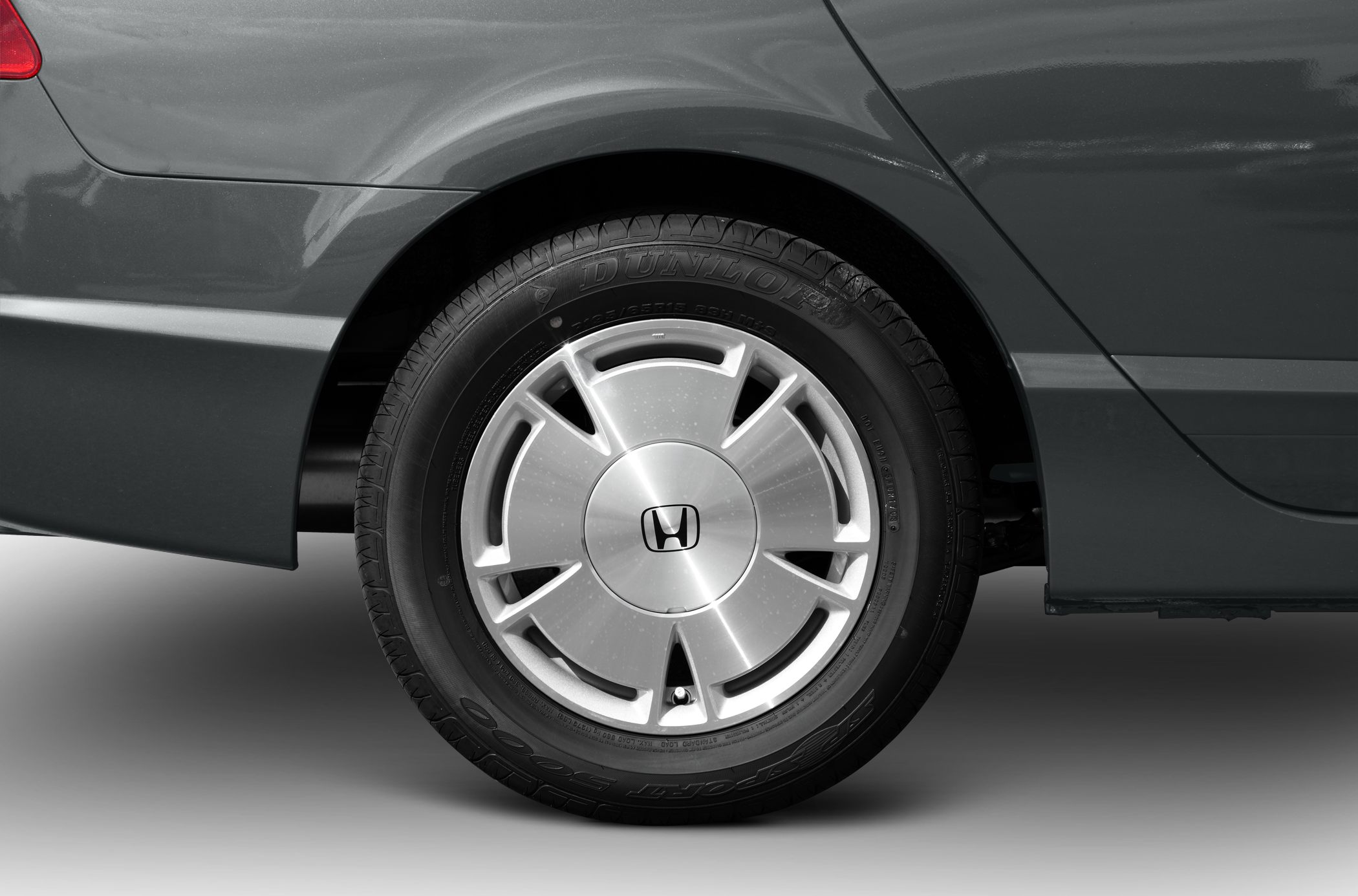 Close-up of alloy wheel and tire on a sedan vehicle.