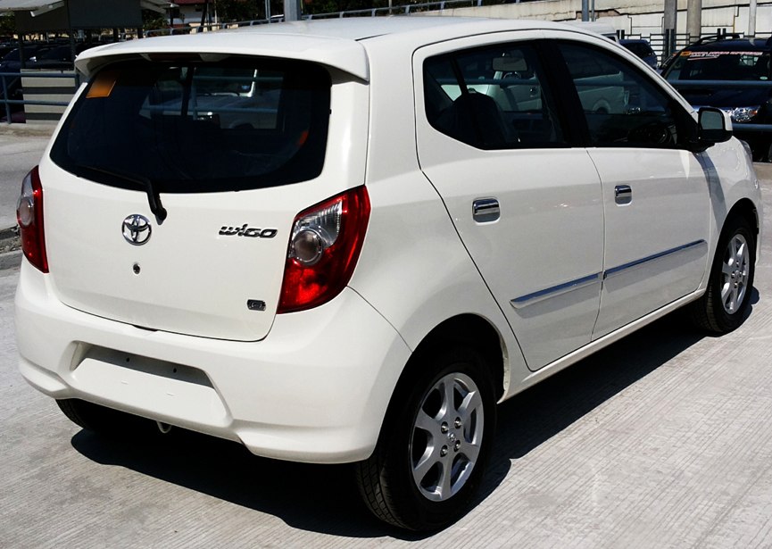 White compact hatchback rear side view with spoiler and unique taillights