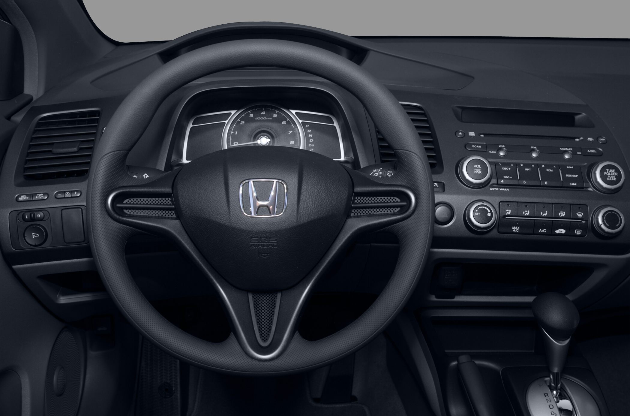 Steering wheel and dashboard controls with speedometer and radio