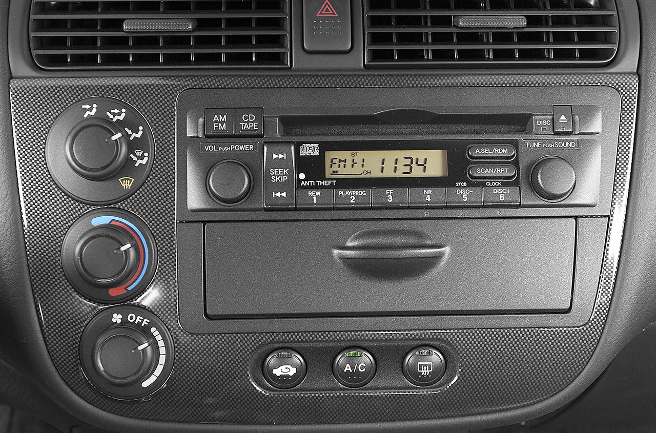 Center console with radio, climate control knobs, and air vents