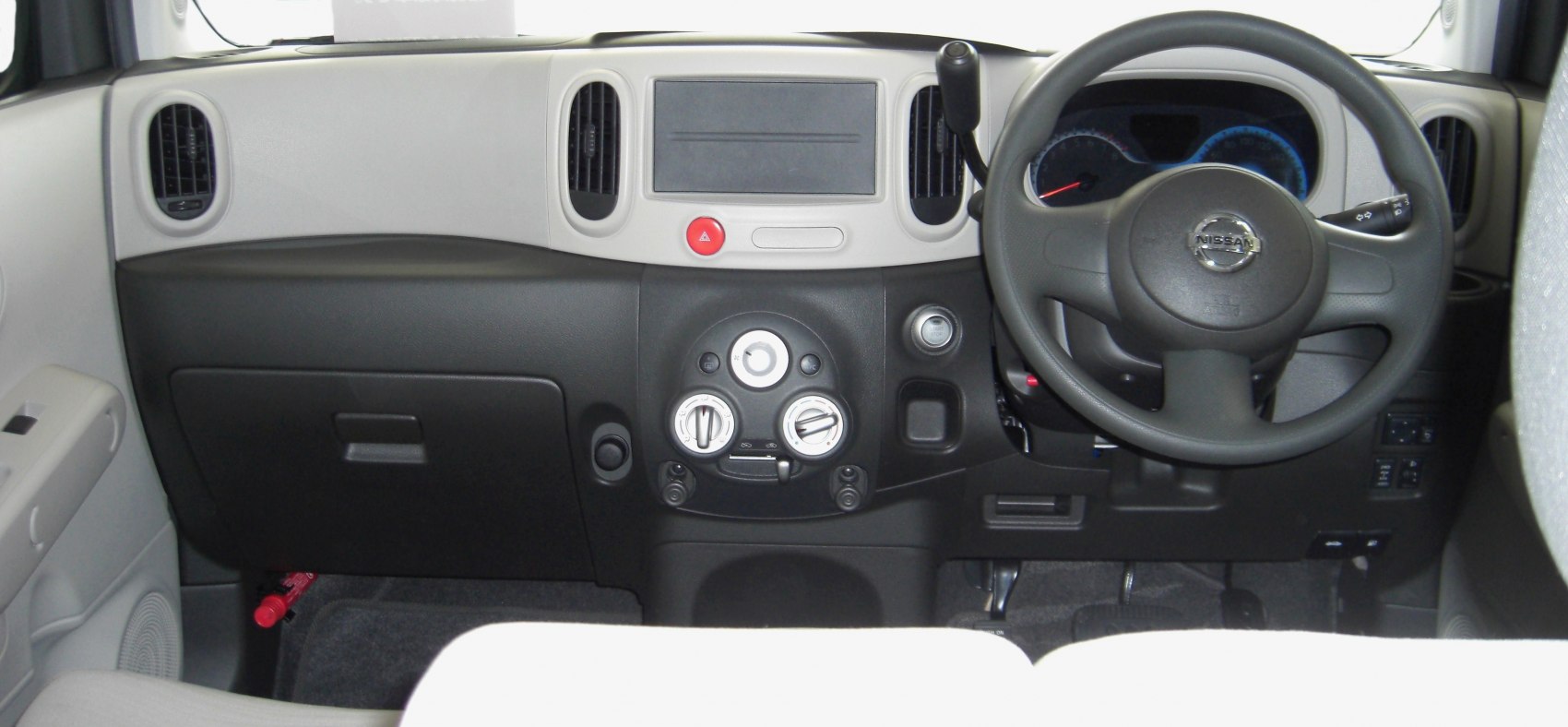 Dashboard and steering wheel layout of a compact car interior