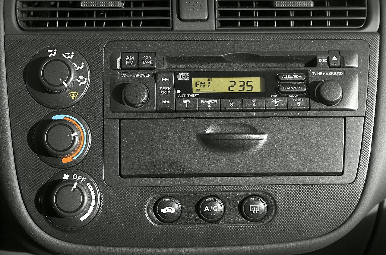 Car radio and climate control panel with knobs and buttons