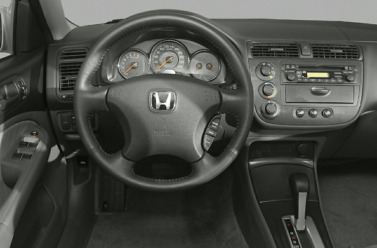 Steering wheel, dashboard, automatic gear shifter, radio and climate controls.