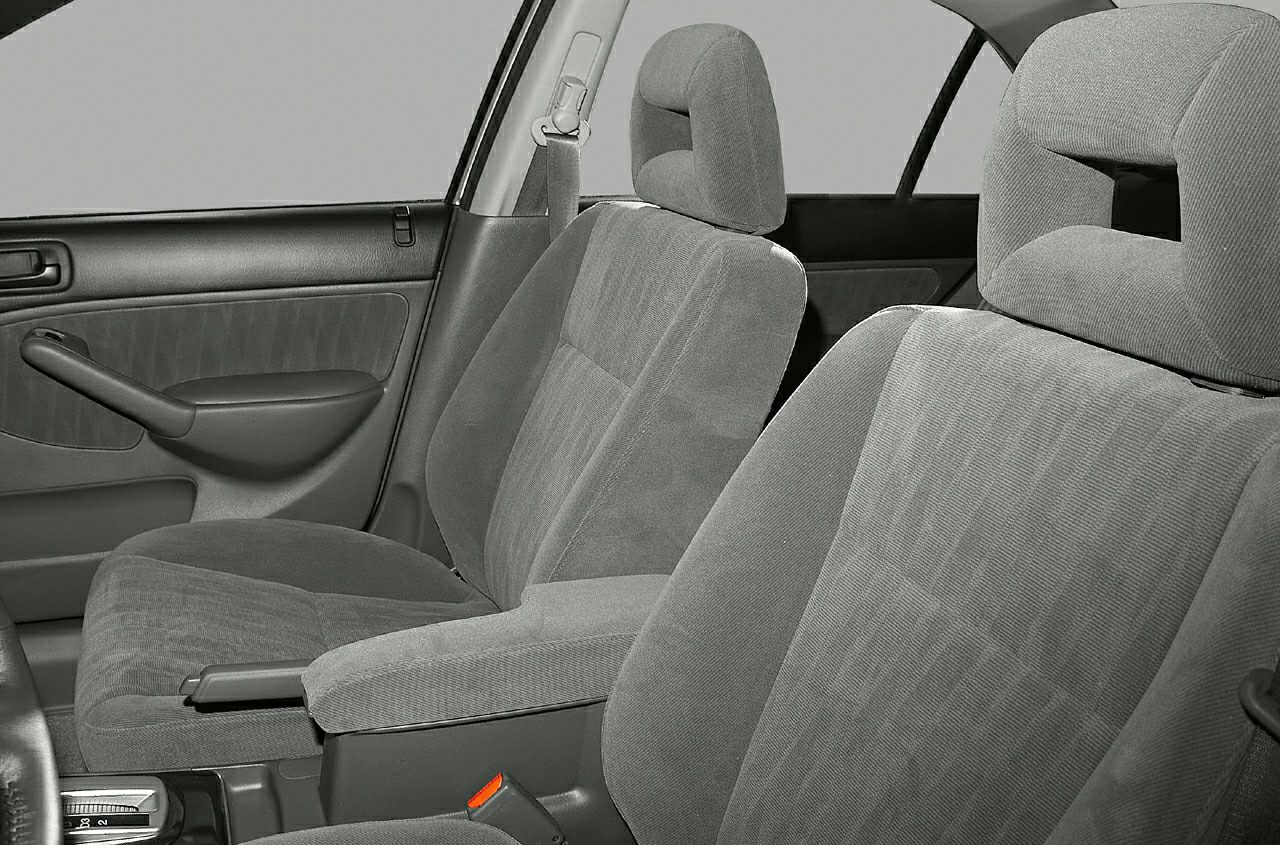 Fabric front seats with ergonomic headrests and door panel armrest.