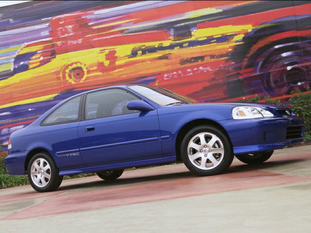 Sleek side profile of blue compact coupe with VTEC badge and alloy wheels