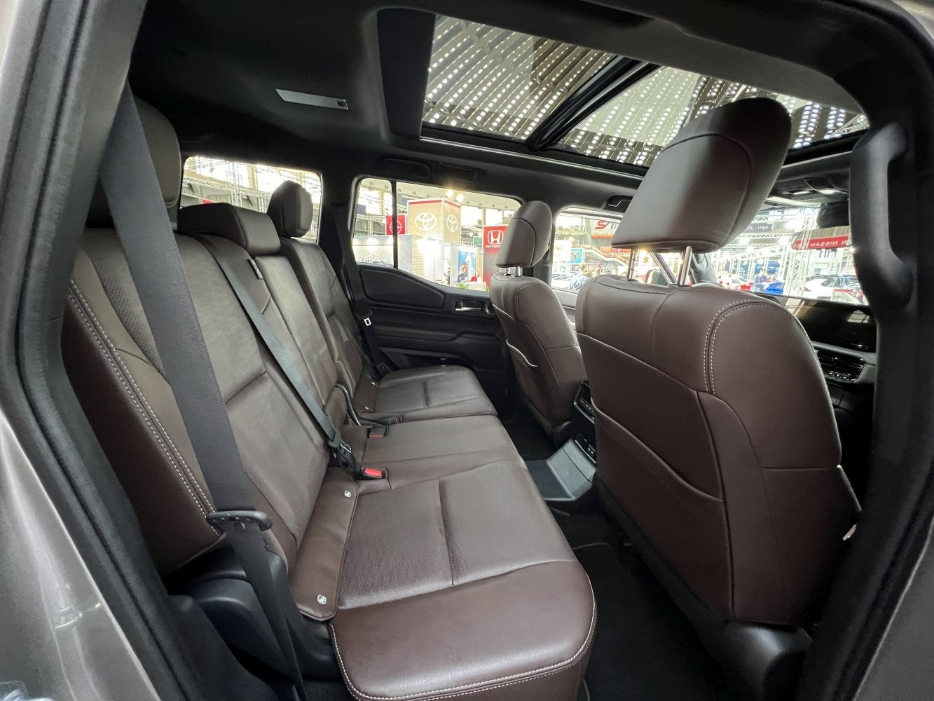 Rear leather seats with panoramic sunroof in luxury SUV interior