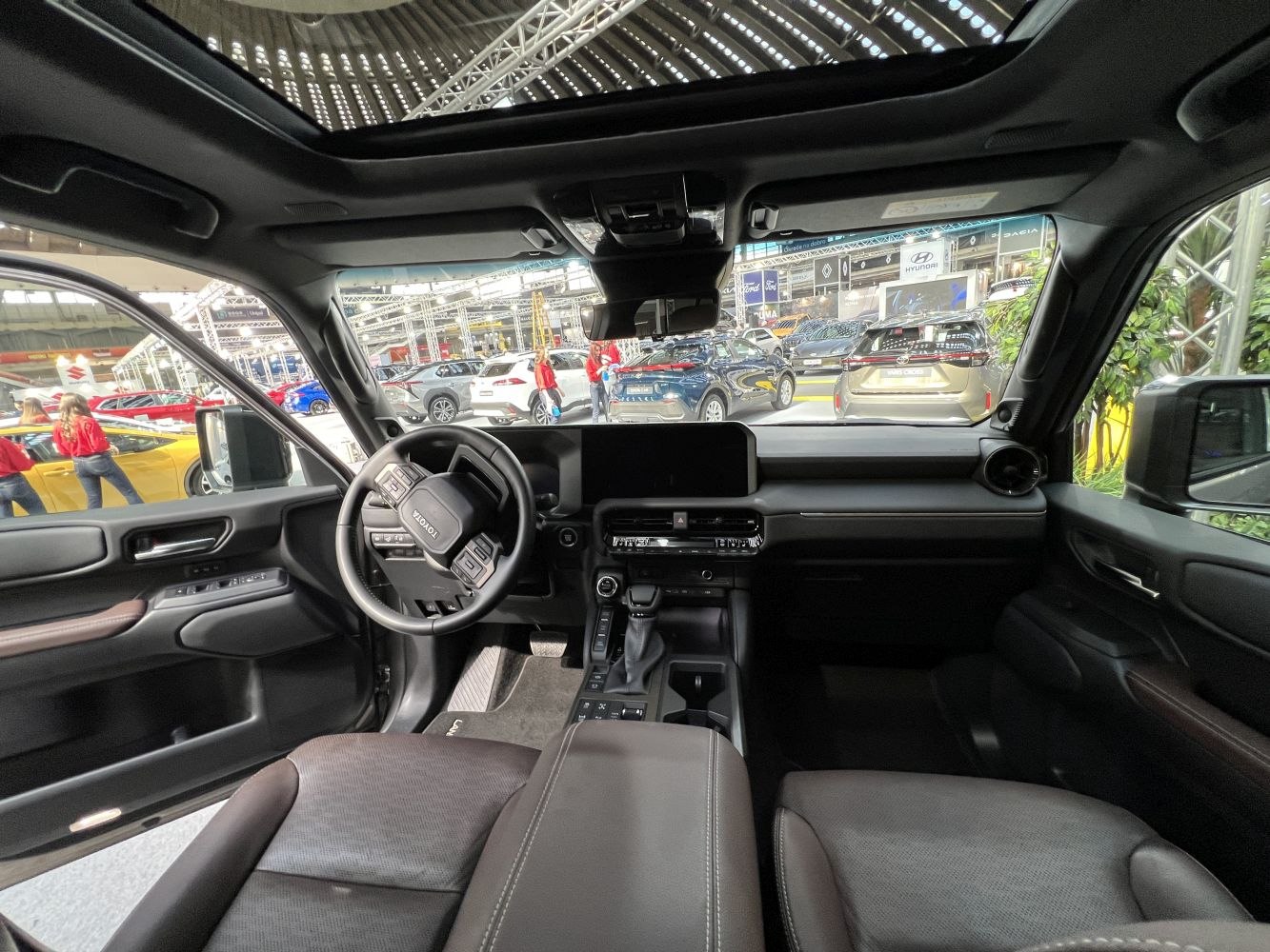 Dashboard, steering wheel, and panoramic sunroof interior view