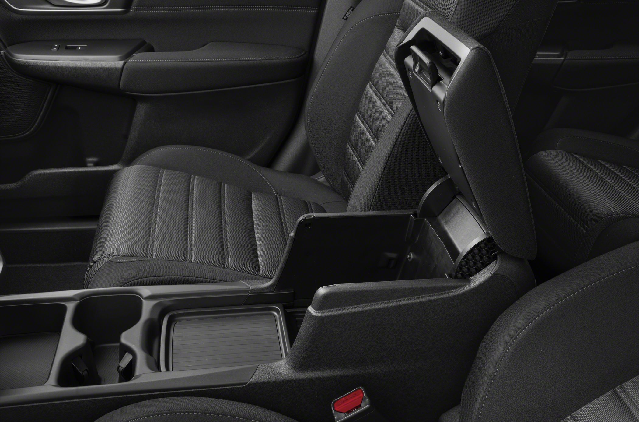 Center console with open storage compartment and dual cup holders in car interior