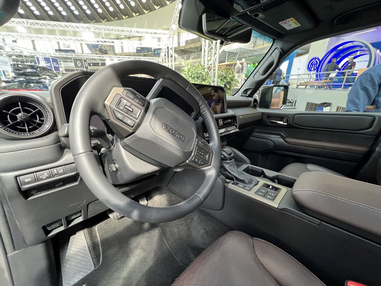Modern steering wheel with control buttons and digital display inside a vehicle