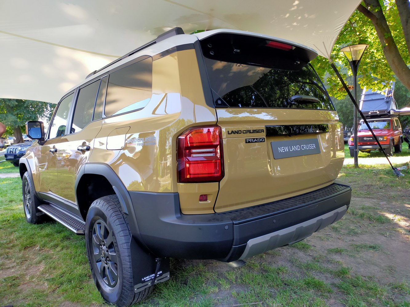 Rear and side view of rugged 2024 SUV with modern tail lights and step boards