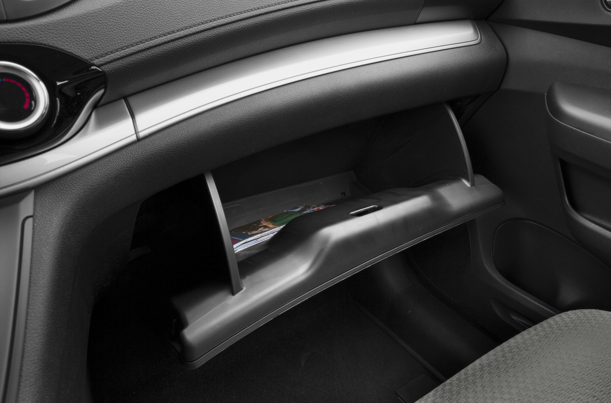 Open glove compartment in car interior
