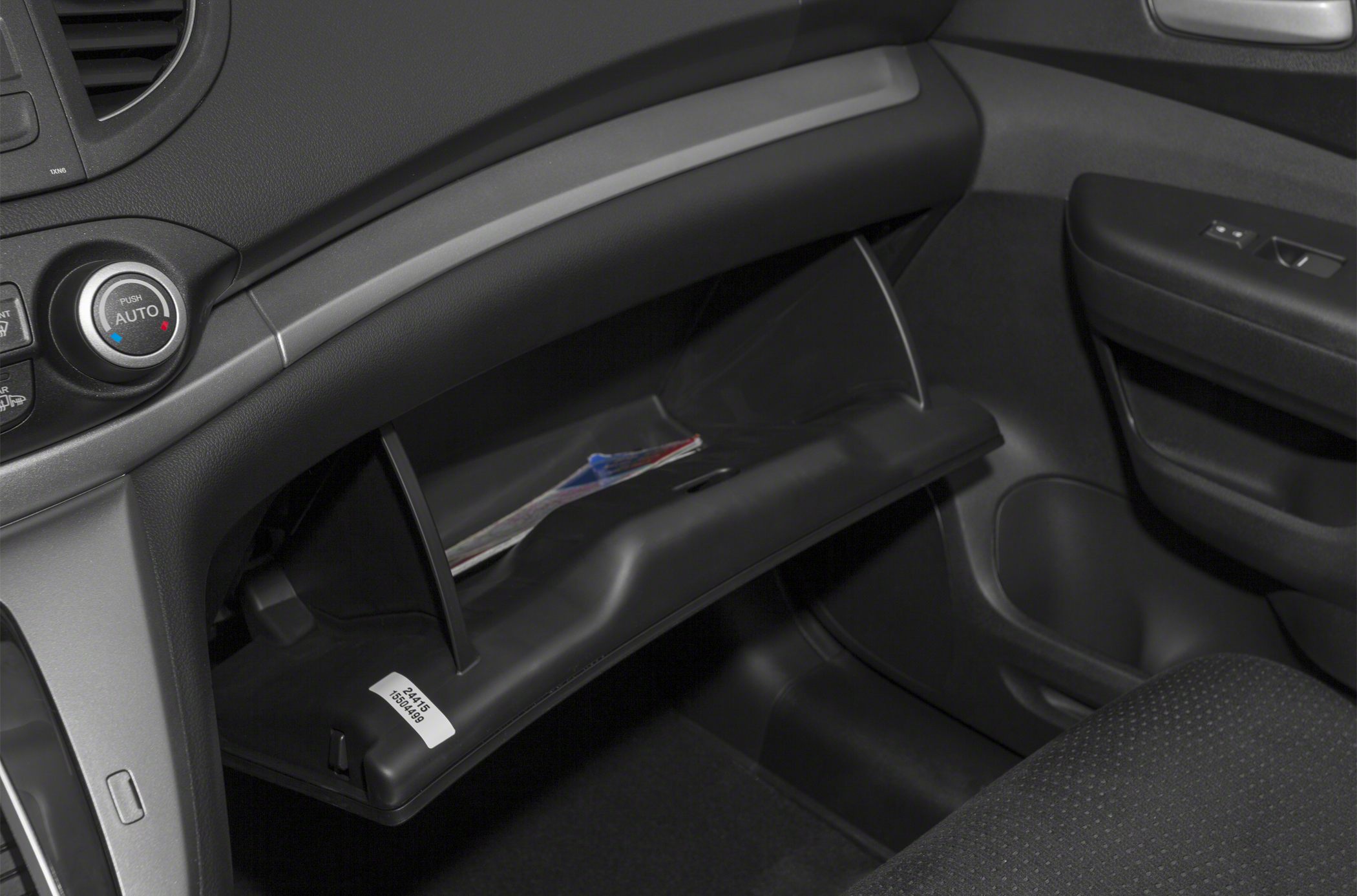 Open glovebox and dashboard controls in car interior