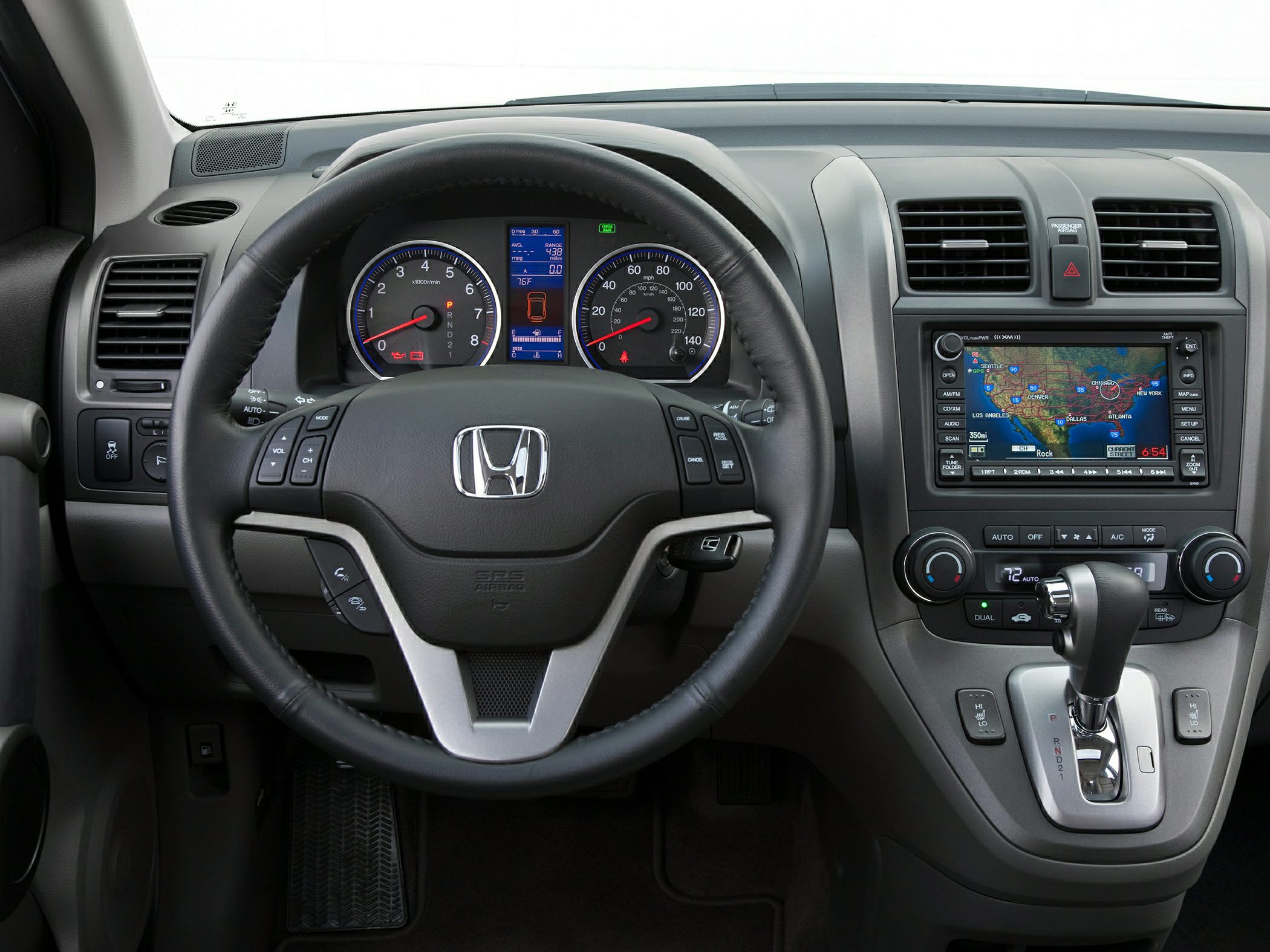 Steering wheel, instrument cluster, gear lever, and infotainment system.