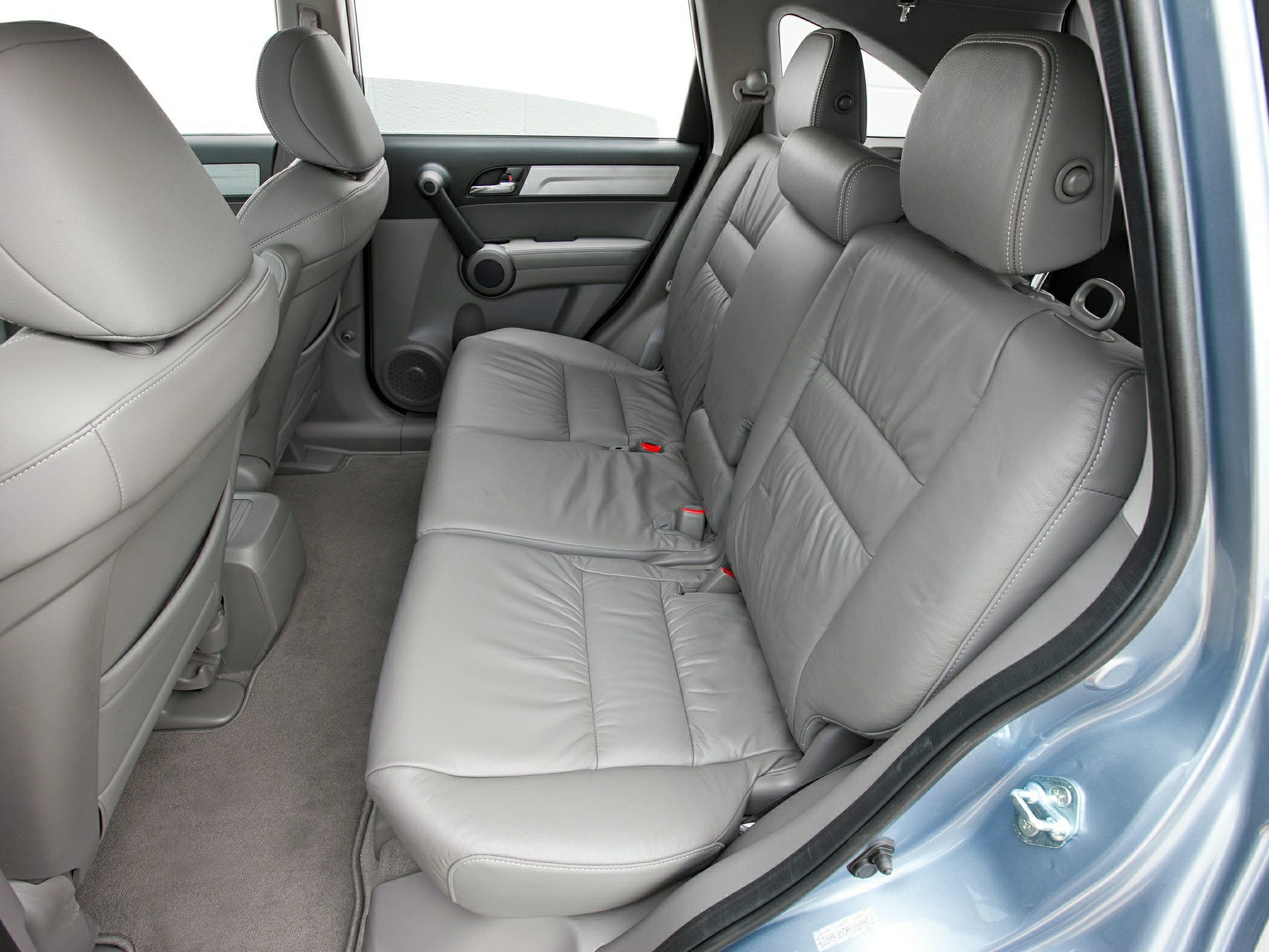 Gray leather rear seats with spacious legroom and detailed door panel.