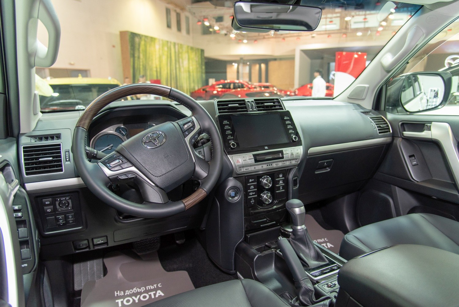 Interior dashboard with leather steering wheel and advanced infotainment system.