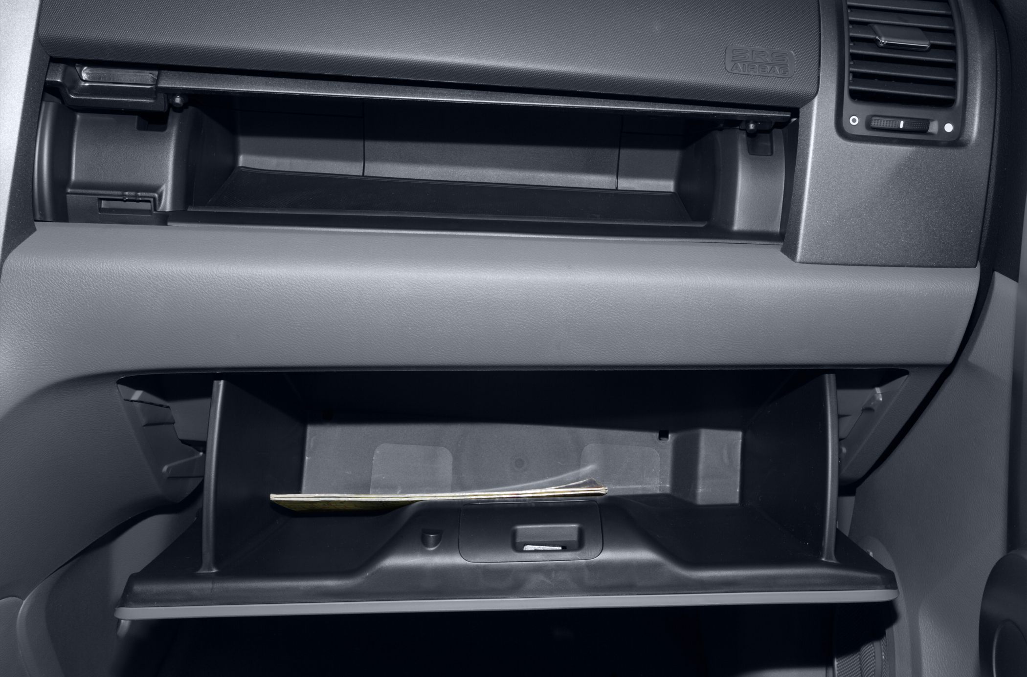 Dual open glove compartments in car dashboard with visible storage space