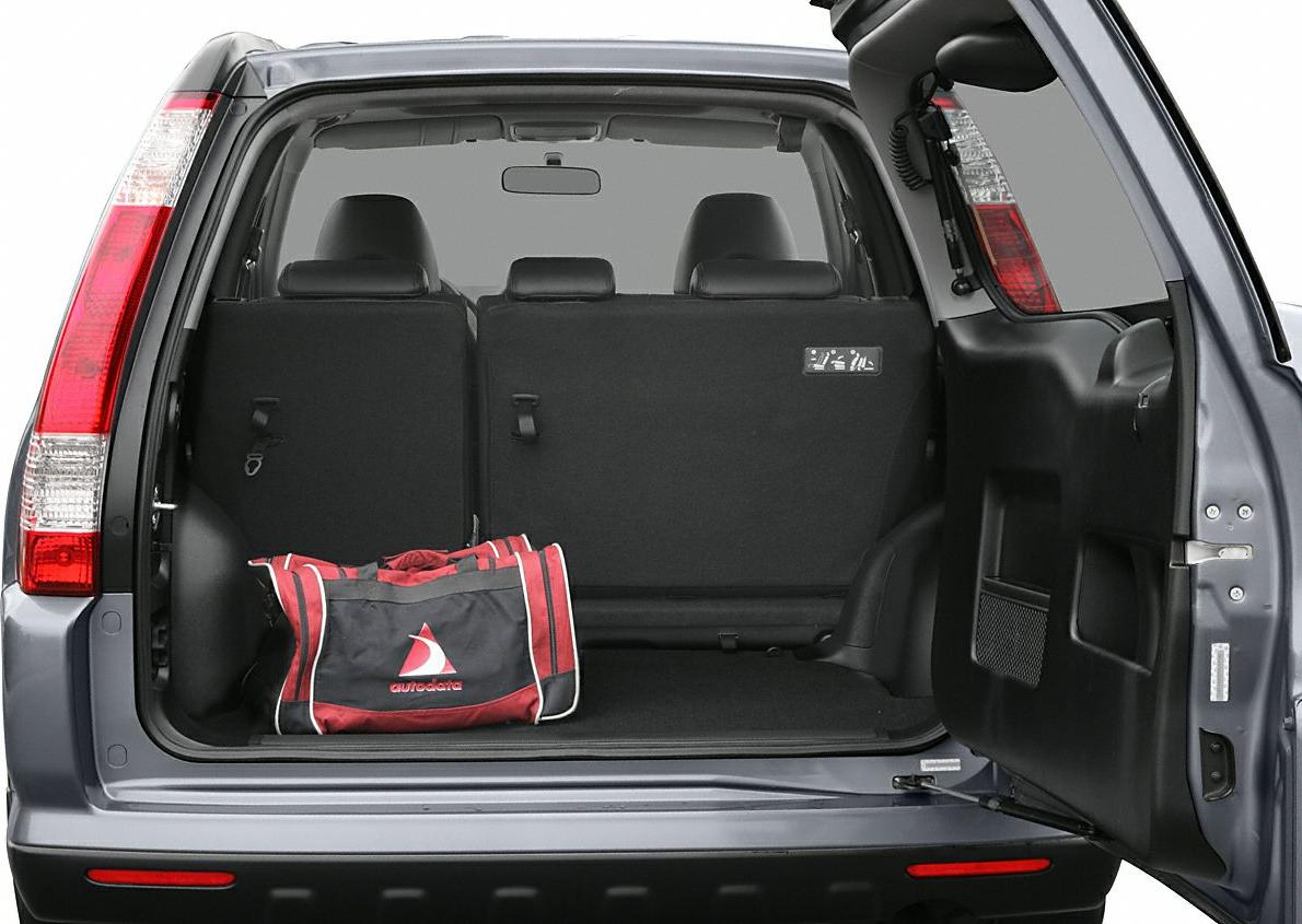 Spacious rear cargo area with foldable back seats and an open rear door.