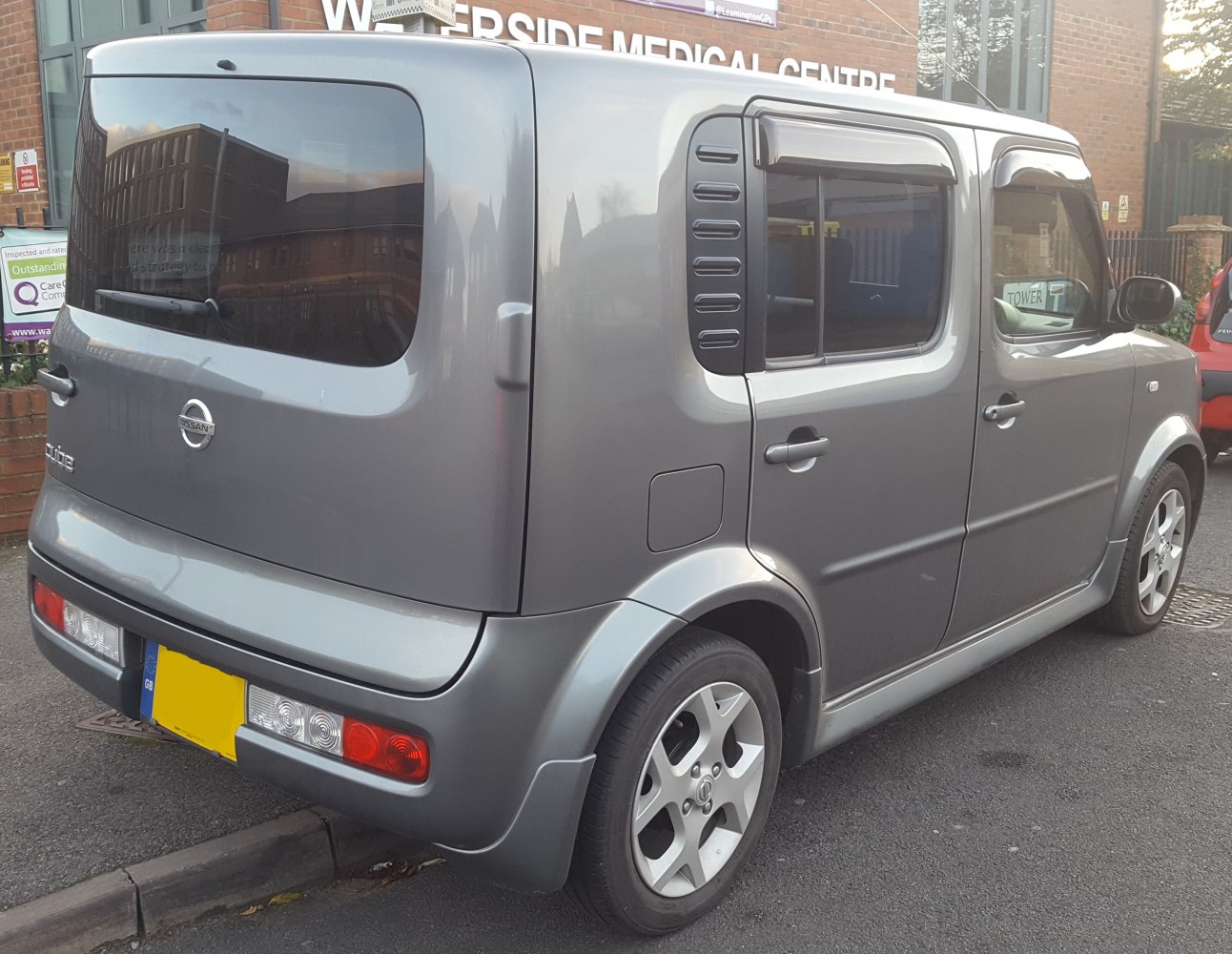 Compact boxy hatchback with distinctive rear window and five-door design
