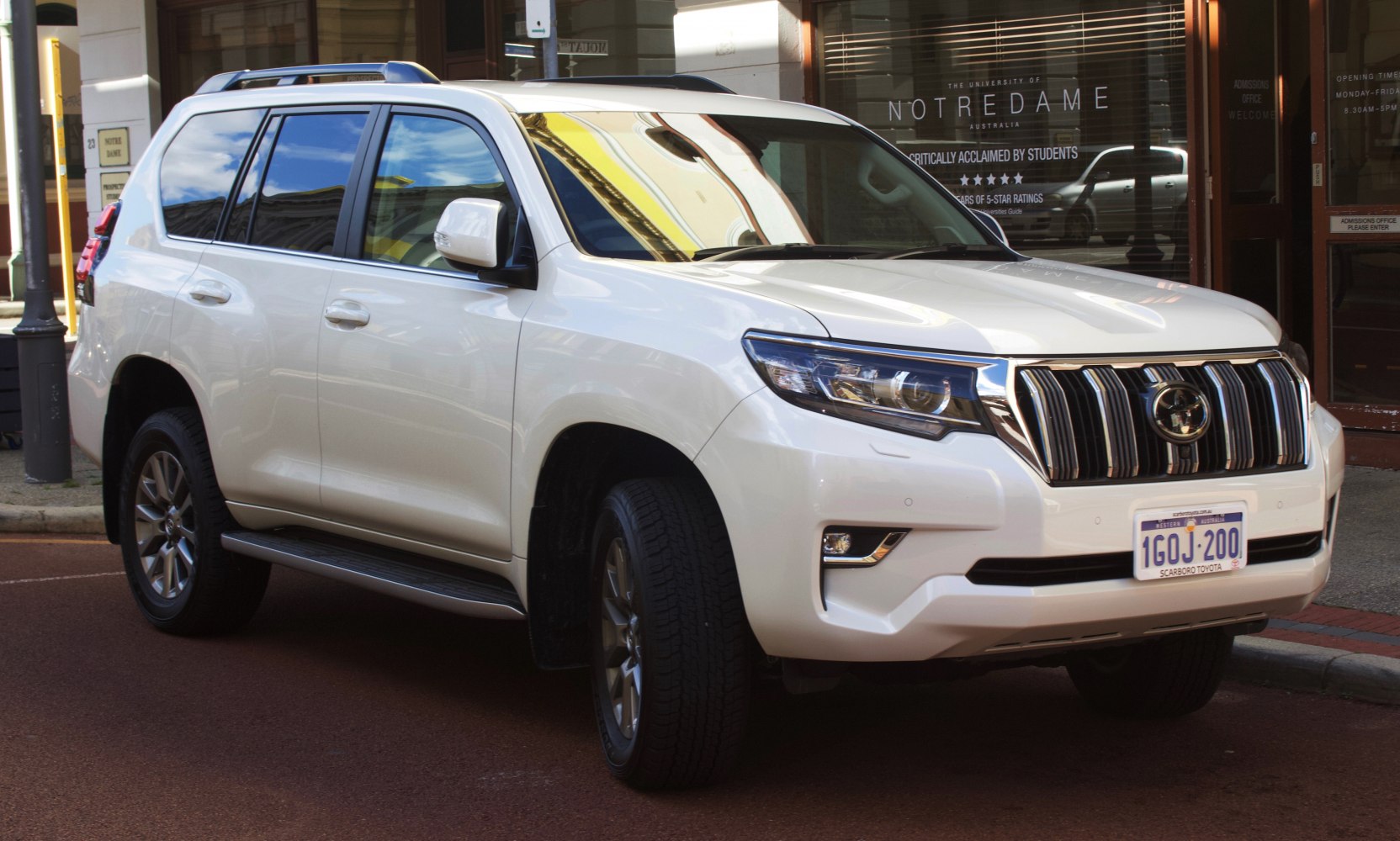 White SUV with chrome grille and LED headlamps front side view