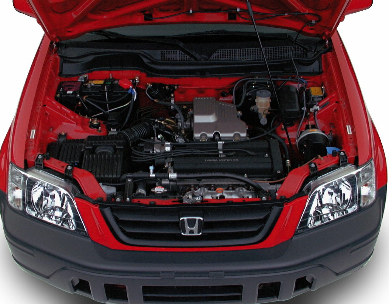Open hood showing engine bay and front headlights of a vehicle.