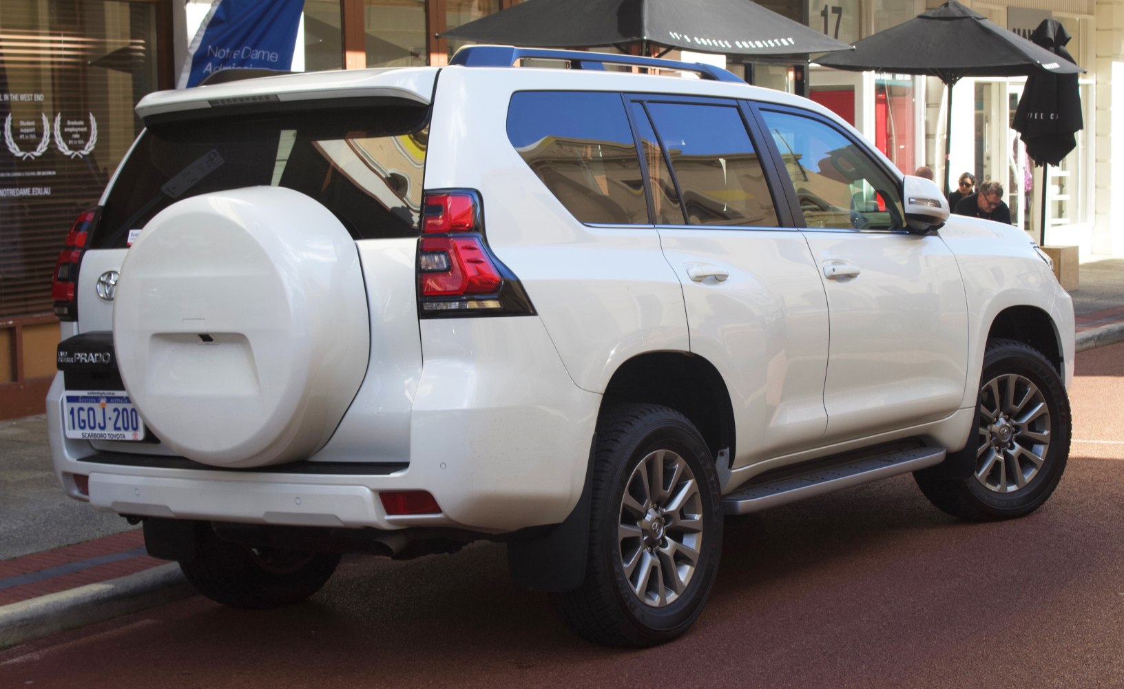 Rear side view with spare tire and alloy wheels