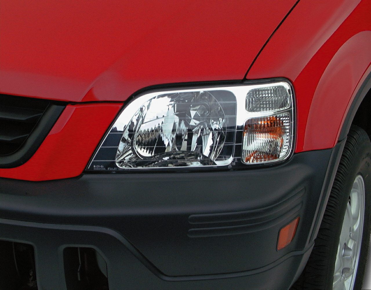 Close-up of front headlight and bumper with orange side marker