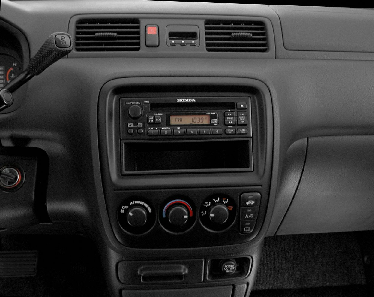 Center console with vintage radio and manual climate control knobs.