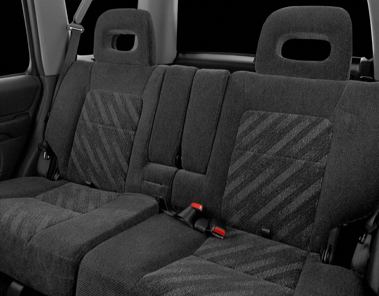 Rear seat upholstery with fabric pattern and integrated headrests.