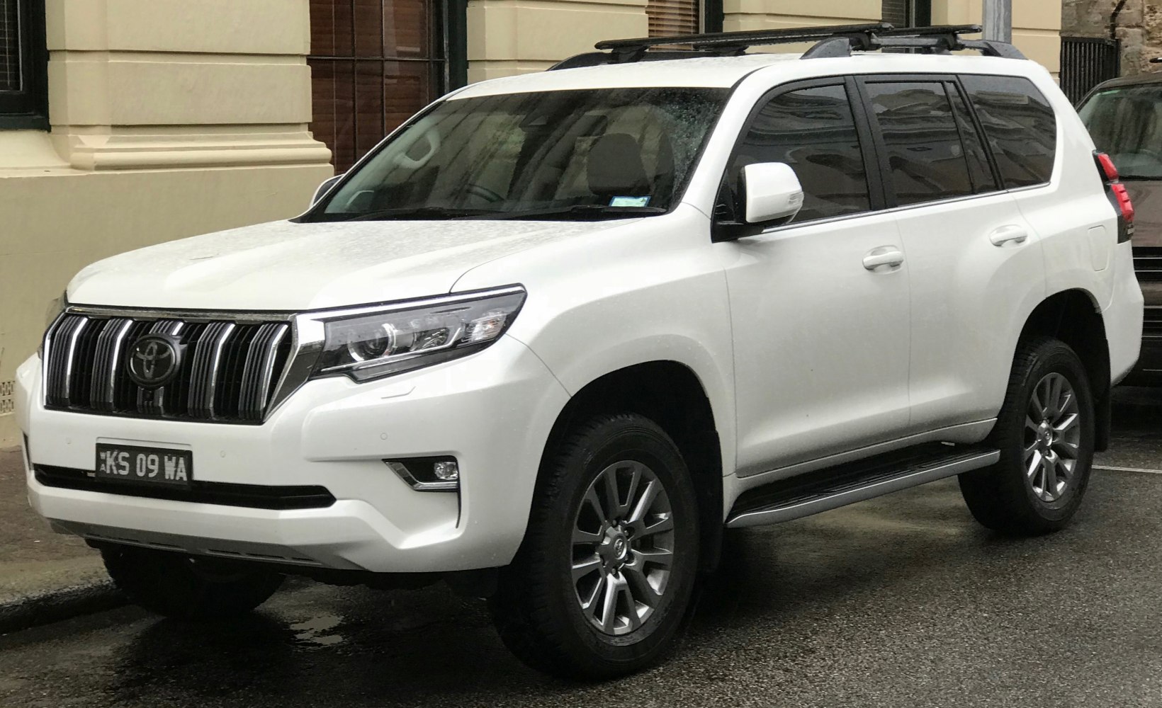 White mid-size SUV front side with grille and headlights