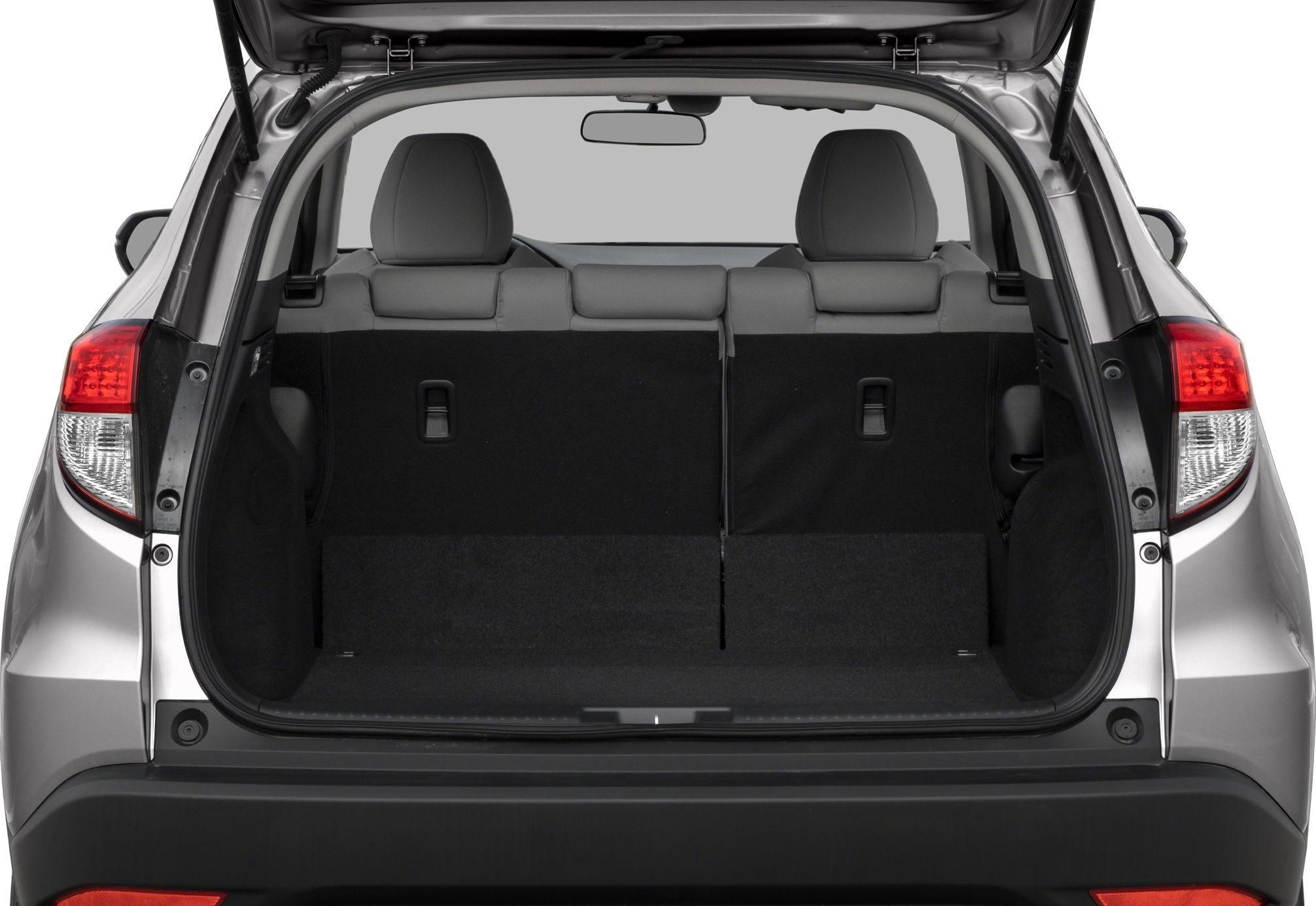 Rear trunk space with split folding rear seats and hatchback open.