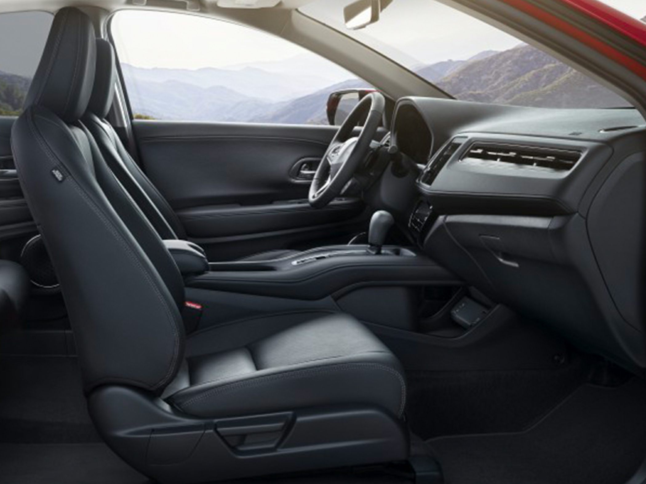 Front seats, steering wheel, and dashboard interior view