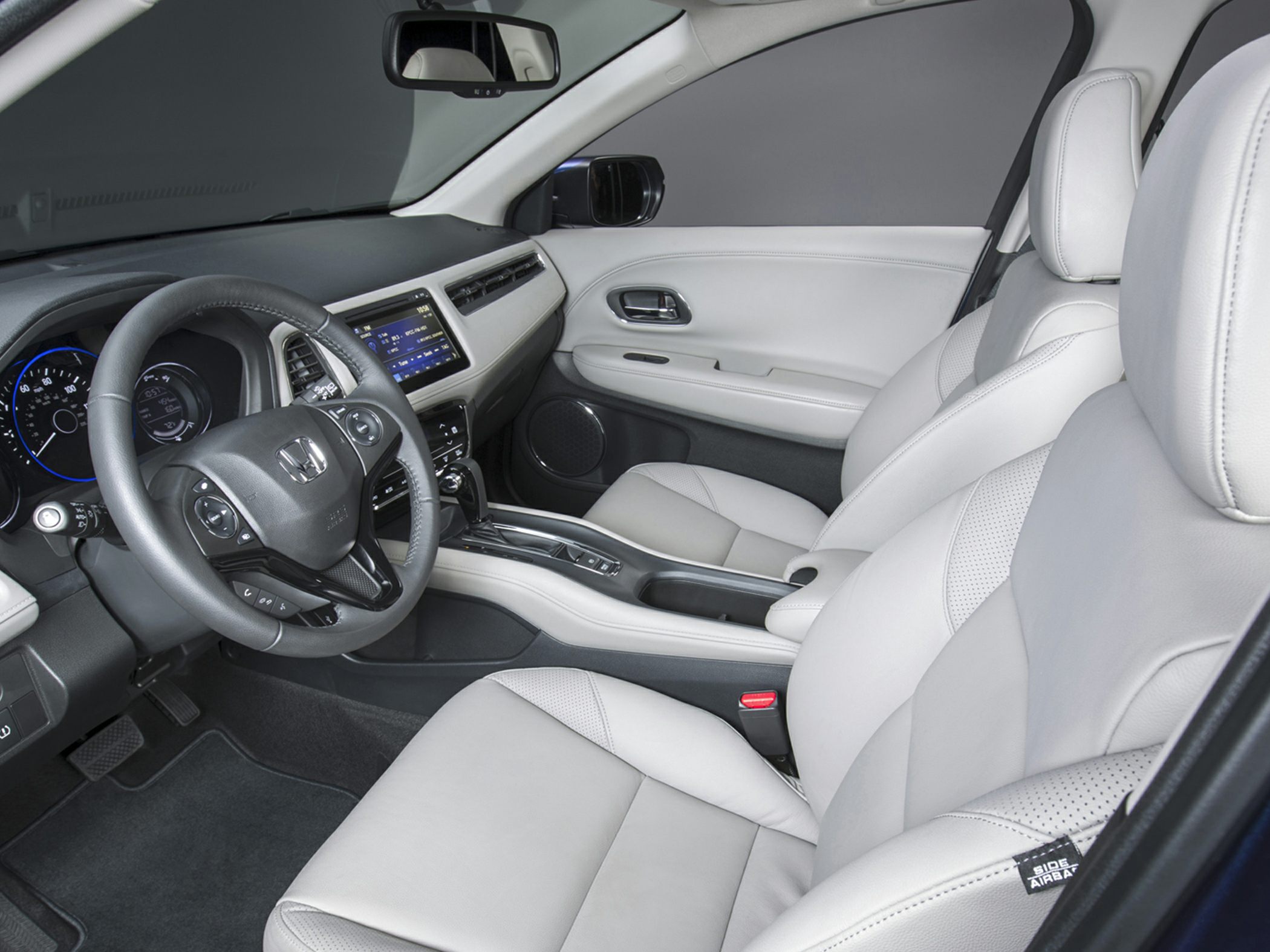 Interior dashboard with digital display and light leather seats