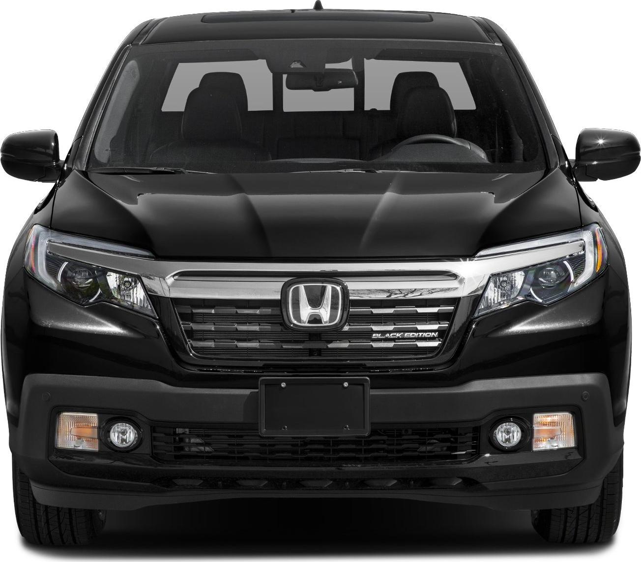 Front view showcasing grille and headlights of a pickup.