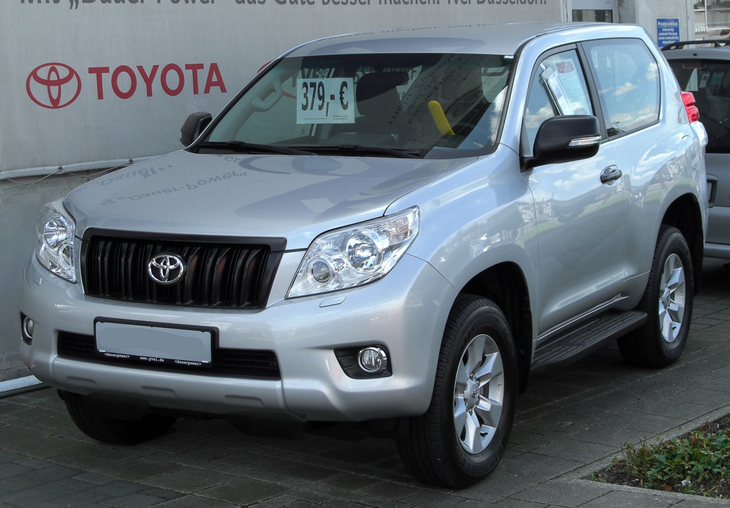Silver 3-door SUV front and side view with prominent grille and headlights