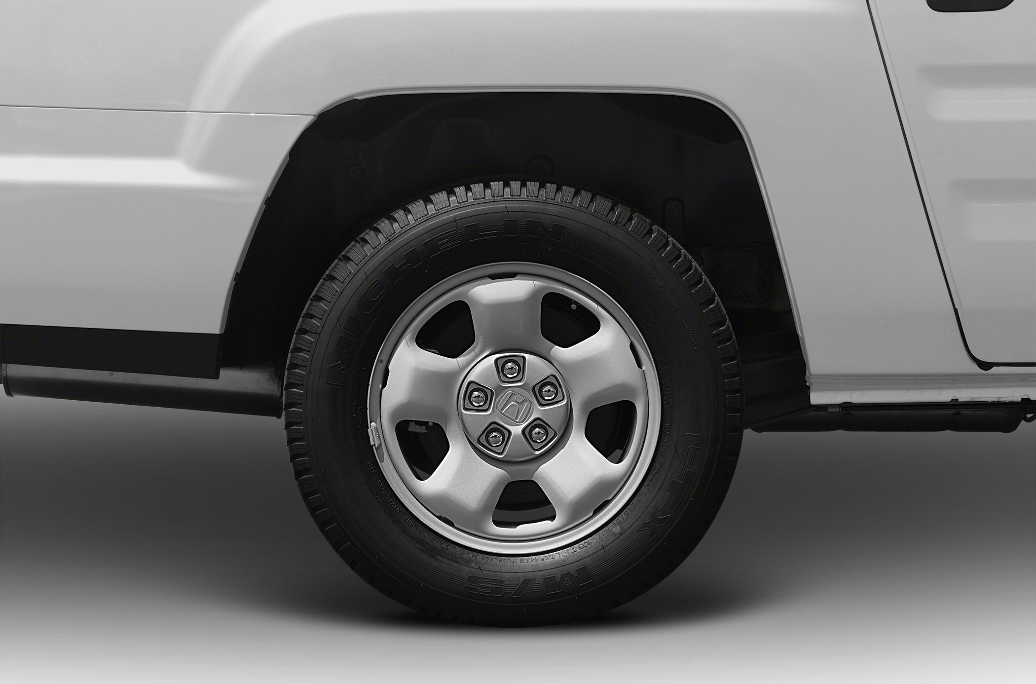 Close-up of alloy wheel and tire on vehicle side