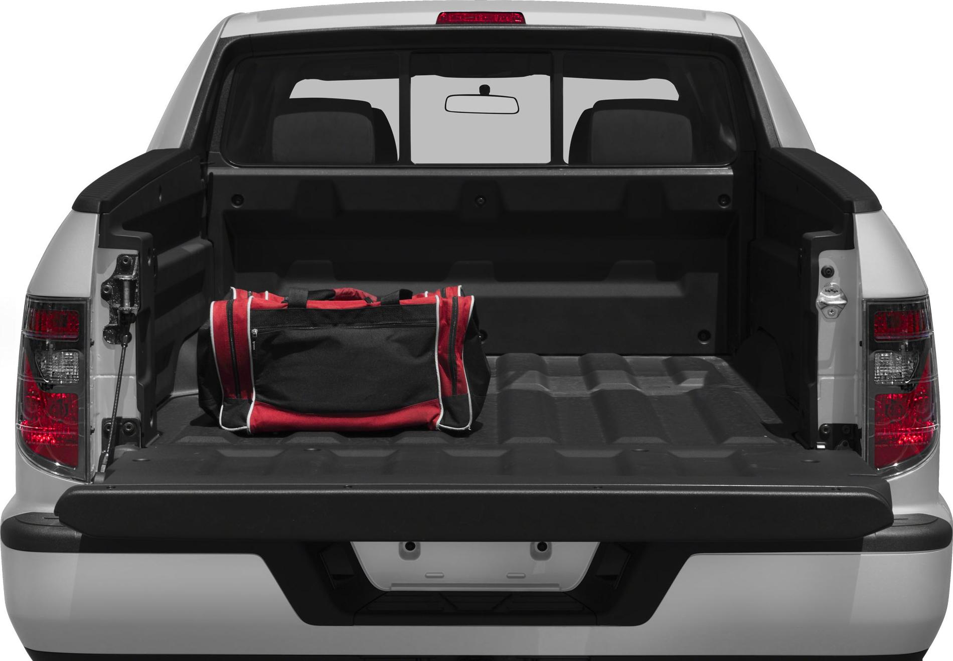 Open pickup truck bed with red and black duffel bag