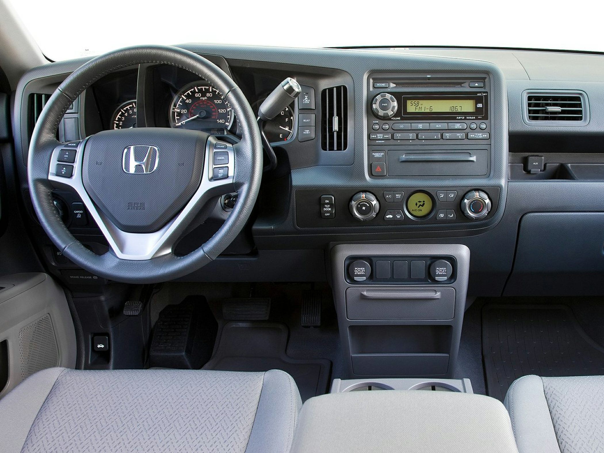 Dashboard and steering wheel with instrument cluster and center console controls