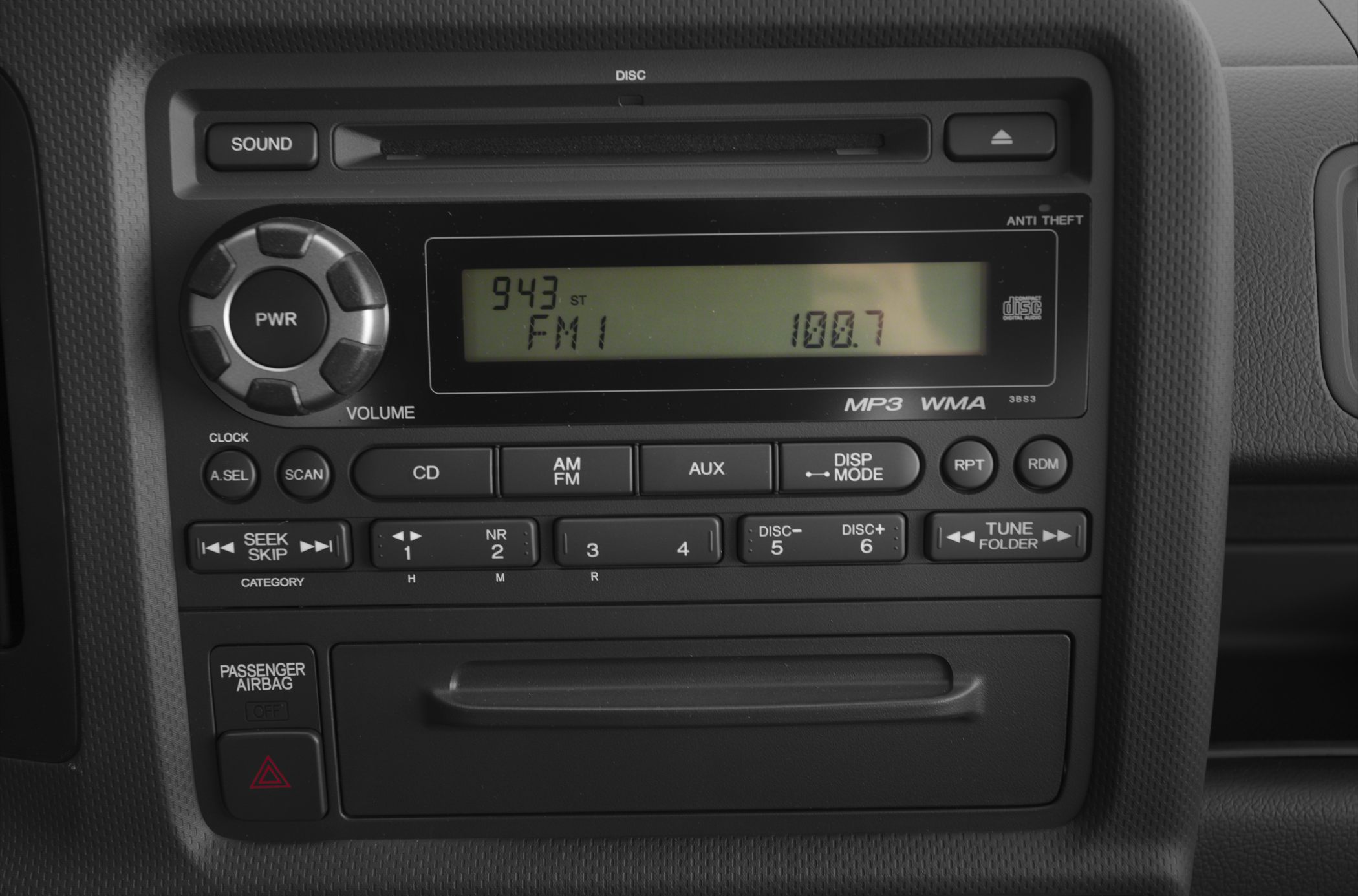 Car stereo controls with MP3, FM/AM radio, CD player, volume knob, and airbag indicator