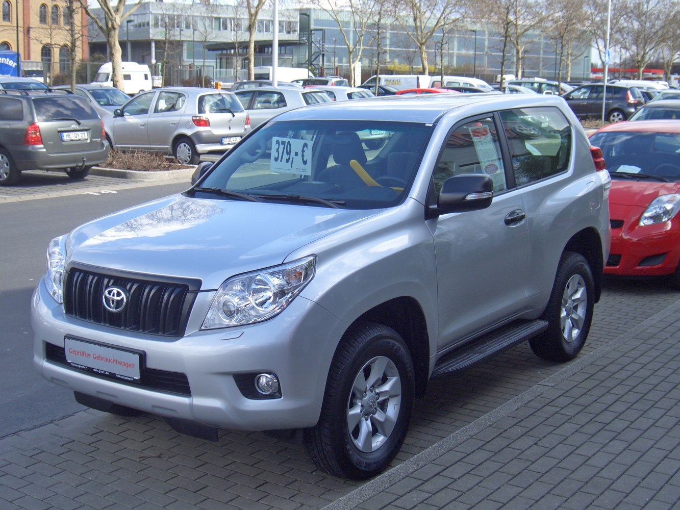 Front three-quarter view of silver SUV with distinctive grille and headlights