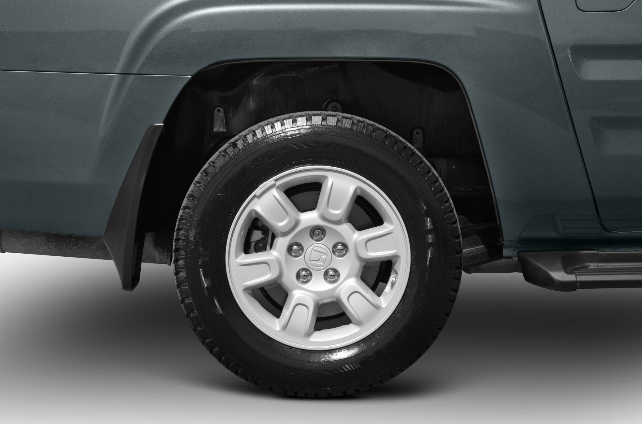 Alloy wheel and tire close-up with wheel arch and fender