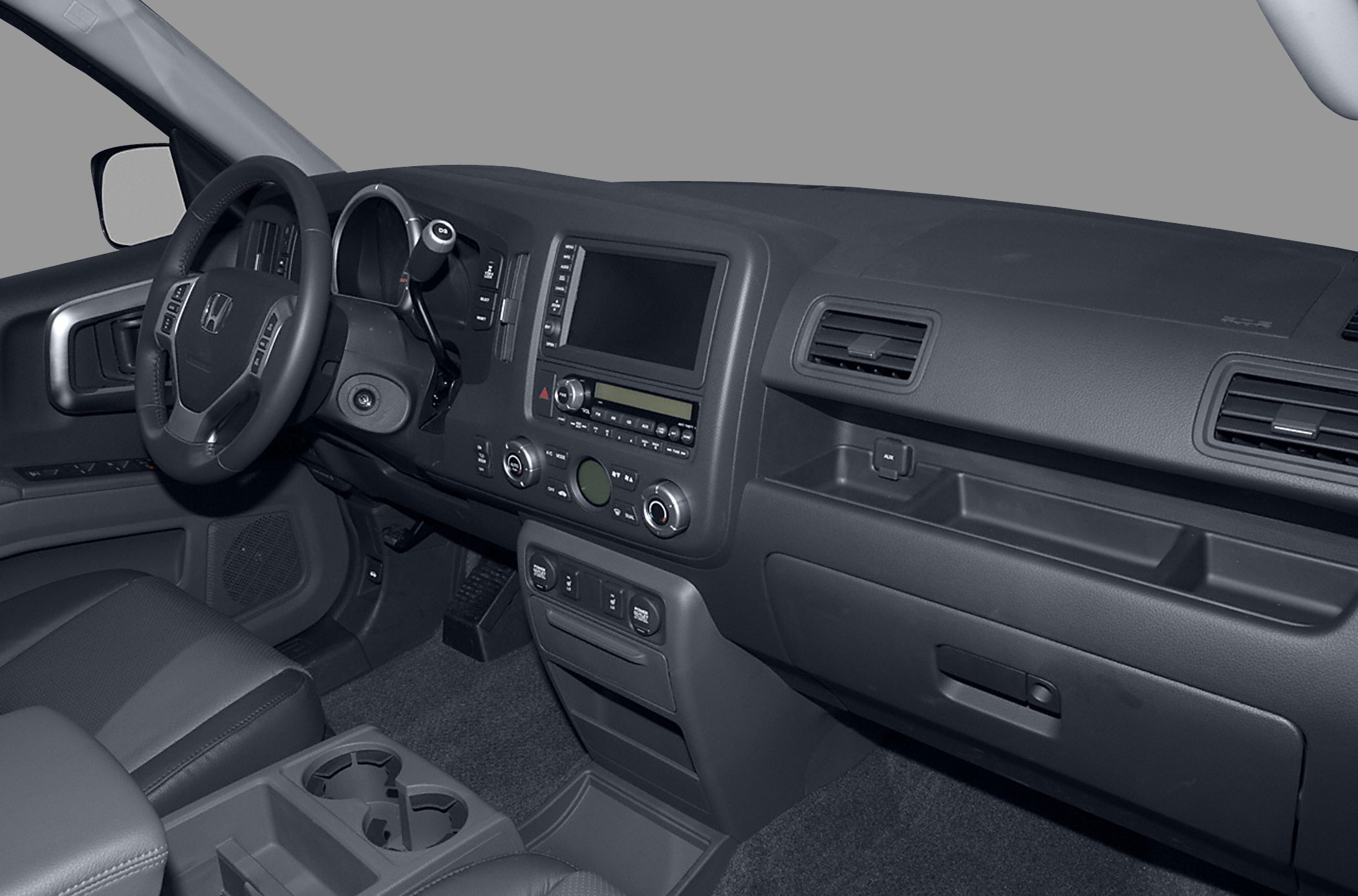 Car interior with dashboard, steering wheel, center console, and passenger seat