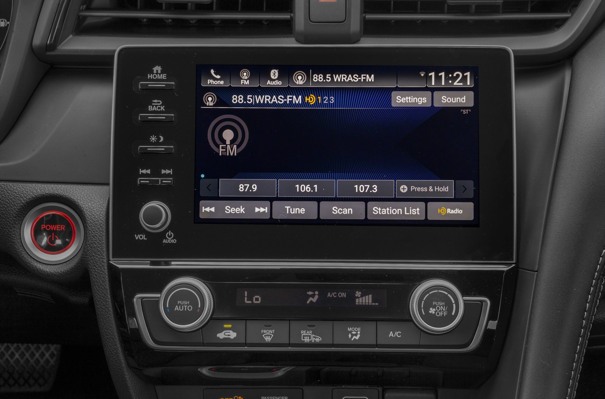 Radio tuner touchscreen and climate control panel with physical buttons and dials